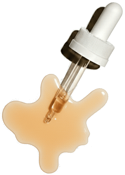 A glass dropper with a white cap rests on a surface, surrounded by a spill of light peach-colored liquid.