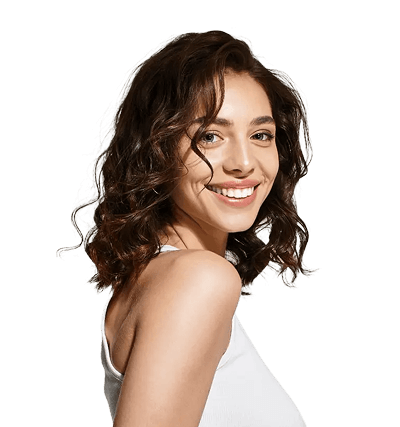 Woman with shoulder-length curly brown hair and a white sleeveless top smiling at the camera against a plain white background.